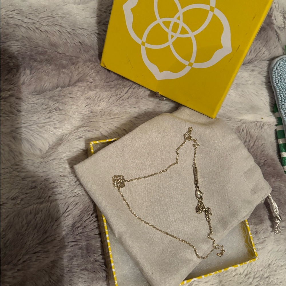 Kendra Scott gold logo necklace with dust bag and box